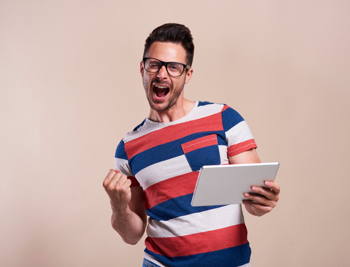 Man Excited and Holding Tablet